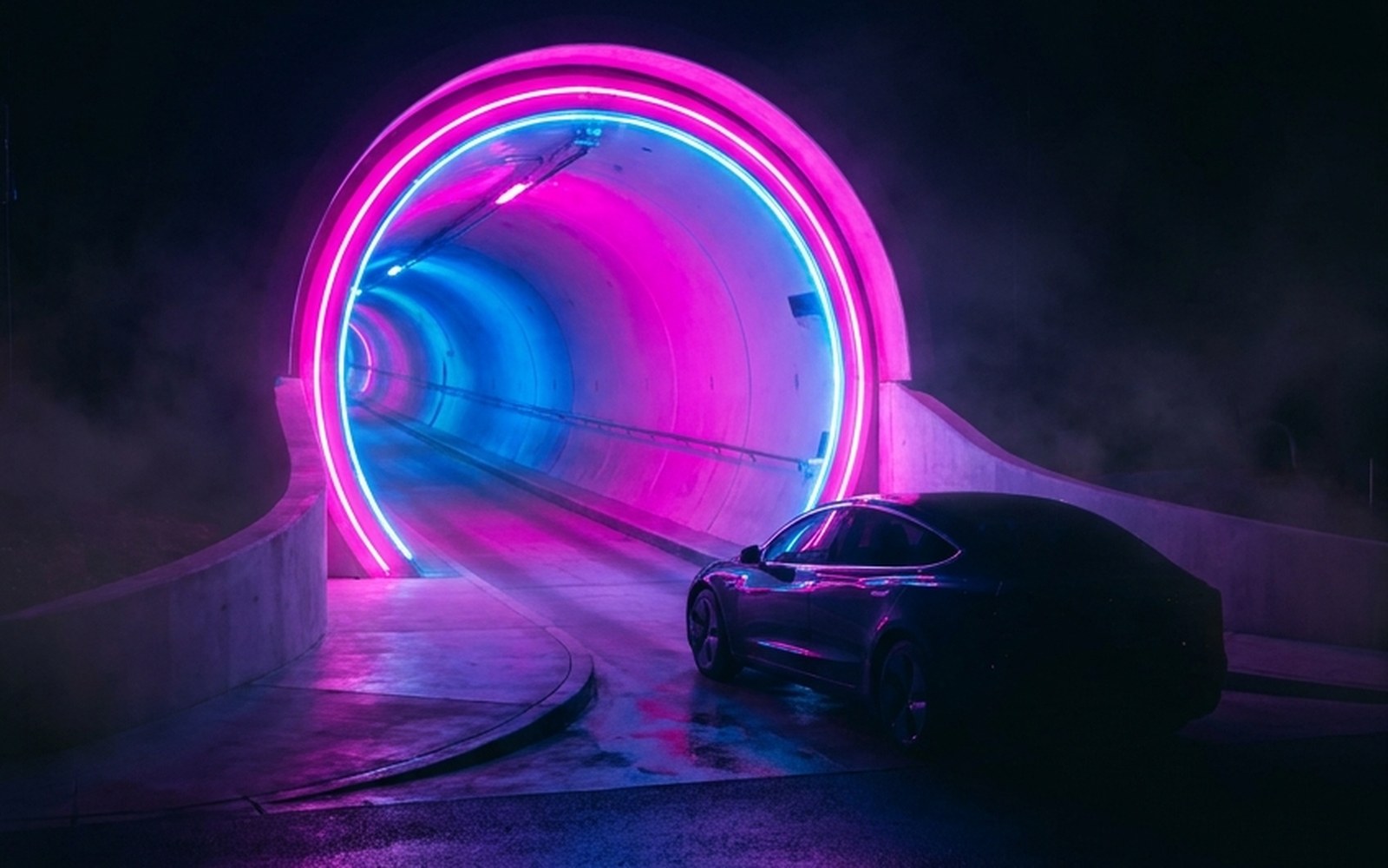 Loop: the pink and blue neon Boring tunnel portal with a Tesla approaching